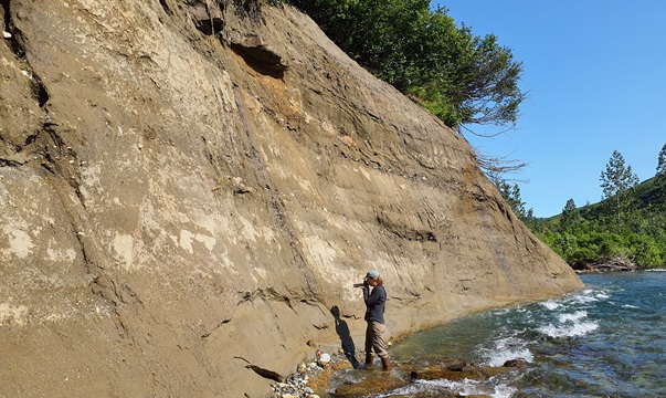 DGGS geologist examines a cut bank of Canyon Creek