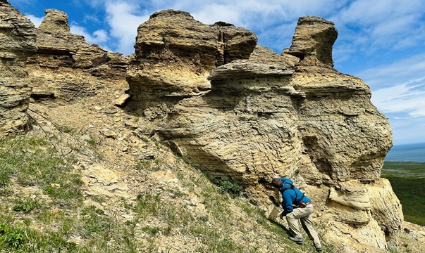 Energy Resources geologist performs fieldwork on Augustine Island